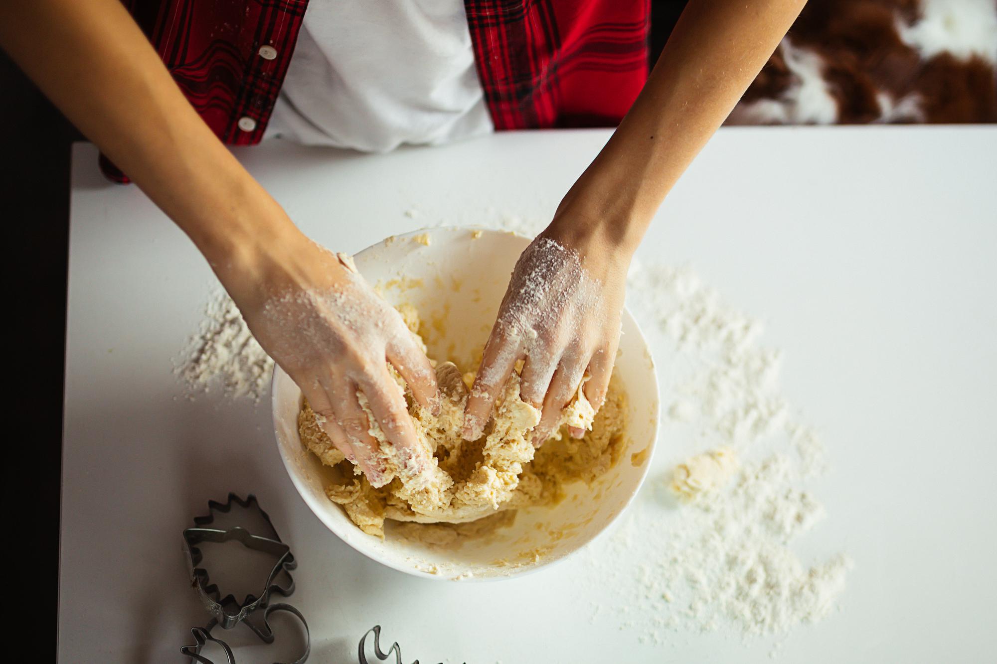 Student kneading dough during a live session
